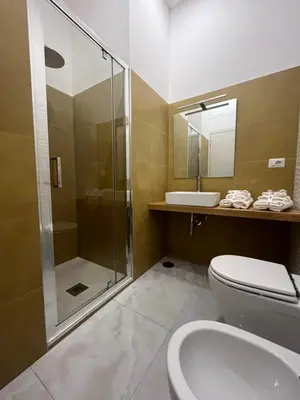 a bathroom with a shower and a toilet and a sink at Green apartment a Porta Pia in Rome