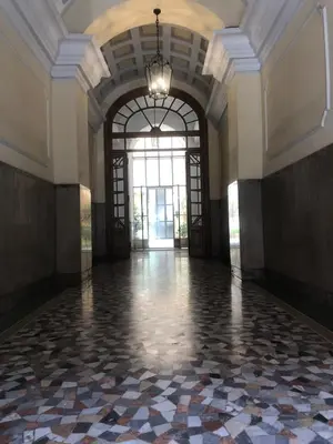 an empty hallway with a large window and a large room at Green apartment a Porta Pia in Rome