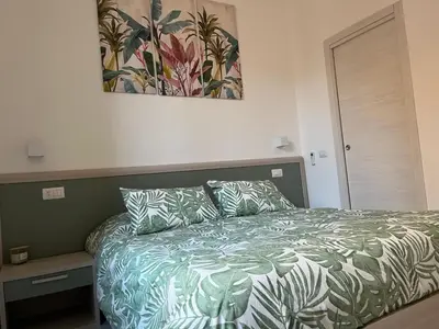 a bedroom with a bed and a painting on the wall at Green apartment a Porta Pia in Rome