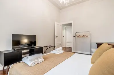 a living room with a couch and a flat screen tv at BBHOME Eleganza e comfort unico in San Giovanni district in Rome