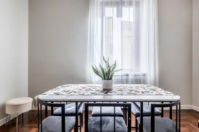 a dining room table with a potted plant on it at BBHOME Eleganza e comfort unico in San Giovanni district in Rome