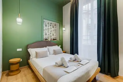 a bedroom with a bed with two towels on it at Vivilo Collection - Charme 24 Suites - Close to Via Veneto in Rome