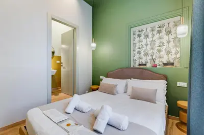 a bedroom with a large white bed with white pillows at Vivilo Collection - Charme 24 Suites - Close to Via Veneto in Rome