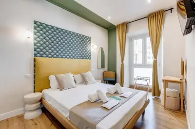 a bedroom with a large bed in a room at Vivilo Collection - Charme 24 Suites - Close to Via Veneto in Rome