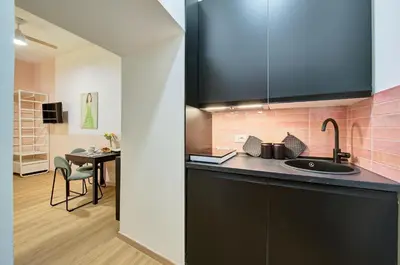 a kitchen with a sink and a table in a room at Vatican Lante Suite in Rome