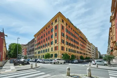 a large orange building with cars parked in front of it at Vatican Lante Suite in Rome