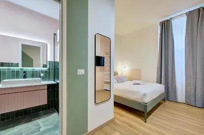 a bedroom with a bed and a sink and a mirror at Vatican Lante Suite in Rome