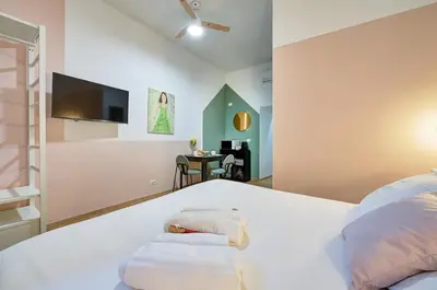 a bedroom with a white bed with a flat screen tv at Vatican Lante Suite in Rome