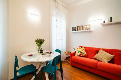 a living room with a red couch and a table at La casina sull'appia in Rome