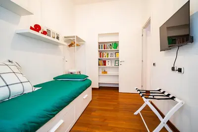 a small bedroom with a bed and a chair at La casina sull'appia in Rome