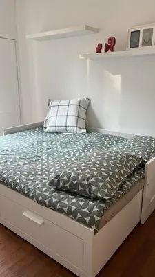 a bed in a white room with a bed frame at La casina sull'appia in Rome