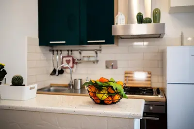 a kitchen with a bowl of fruit on a counter at La casina sull'appia in Rome