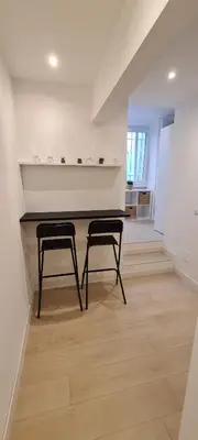 two black chairs in a room with a table at Trastevere incantevole con patio esterno privato in Rome