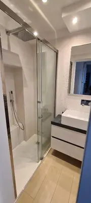 a bathroom with a glass shower and a sink at Trastevere incantevole con patio esterno privato in Rome