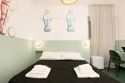 a bedroom with a bed with two towels on it at O Effe Games Vatican in Rome