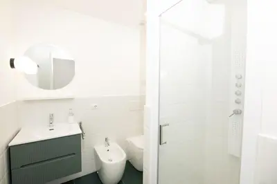 a bathroom with a sink and a toilet and a mirror at O Effe Games Vatican in Rome