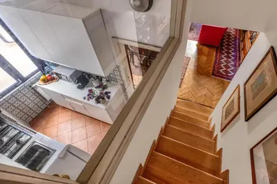 a kitchen with a counter with fruits and wine bottles at NOBILIA - Roof Garden Penthouse near Navona Square in Rome