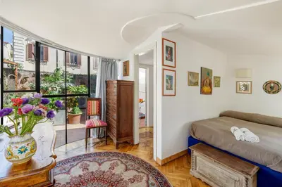 a living room with a table and red chairs at NOBILIA - Roof Garden Penthouse near Navona Square in Rome
