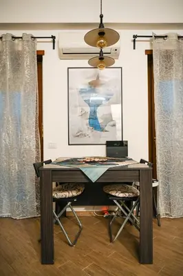 a desk with a laptop and two chairs in a room at Romina in Rome