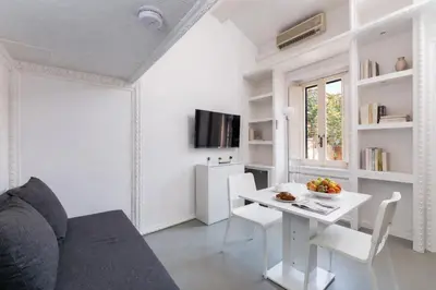 a living room with a couch and a table at Condotti Loft - city center in Rome