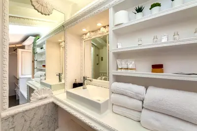 a bathroom with a sink and a mirror at Condotti Loft - city center in Rome