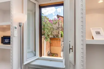 a building in the middle of two other buildings at Condotti Loft - city center in Rome