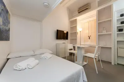 a white room with a bed and a window at Condotti Loft - city center in Rome