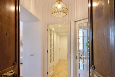 a hallway with a mirror and a chandelier at Casa Frida Arte e Sport tra MAXXI e Olimpico in Rome