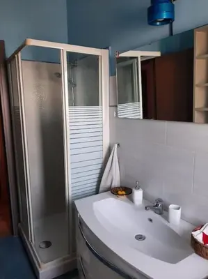 a bathroom with a white sink and a shower at Casa Oscar in Rome