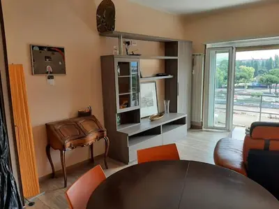 a living room with a table and a chair at Casa Oscar in Rome