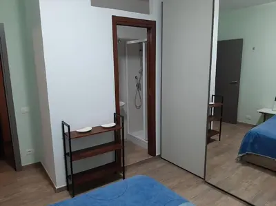 a mirror in a room with a bed and a shower at Casa Oscar in Rome