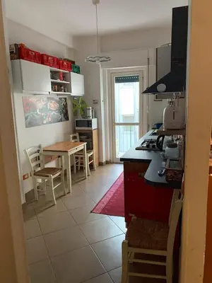 a kitchen and dining room with a table and a kitchen at Bed Bike Breakfast al centro di Roma in Rome
