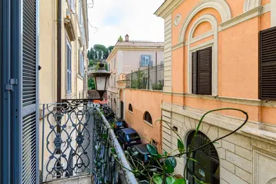 an alley between two buildings with a car parked on a balcony at Colosseum Apartment with Terrace by NDP rent in Rome