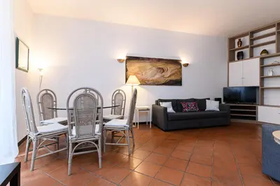 a living room with a couch and a table and chairs at Colosseum Apartment with Terrace by NDP rent in Rome
