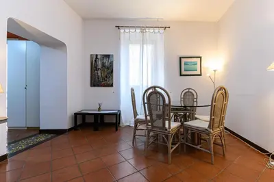 a dining room with a table and chairs at Colosseum Apartment with Terrace by NDP rent in Rome