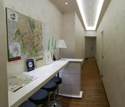 a hallway with a desk with a computer on it at Luxury Rome Savini Guest House in Rome