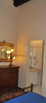 a bedroom with a dresser and a mirror on the wall at Piazza Navona Apartment in Rome