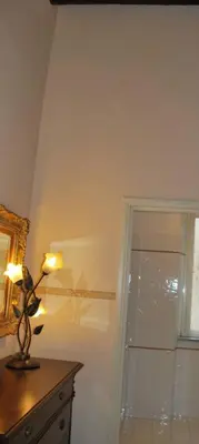 a lamp sitting on top of a dresser next to a window at Piazza Navona Apartment in Rome