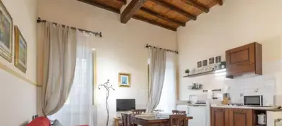 a living room with a table and a kitchen at Piazza Navona Apartment in Rome