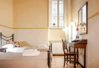 a bedroom with two beds and a desk and a desk at Piazza Navona Apartment in Rome
