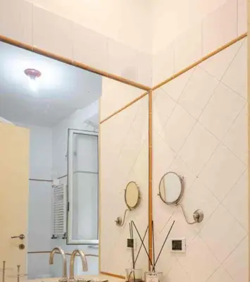 a bathroom with a shower with two mirrors on the wall at Piazza Navona Apartment in Rome