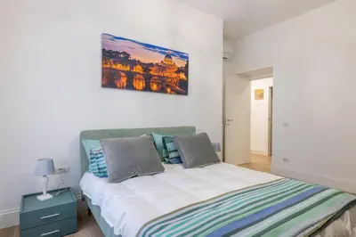 a bedroom with a bed and a painting on the wall at Blessed House in Rome
