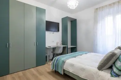 a bedroom with a bed and a desk at Blessed House in Rome
