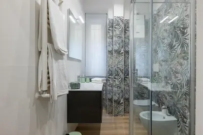 a bathroom with a glass shower and a sink at Blessed House in Rome