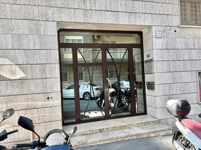 a motorcycle parked in front of a window with cars at Your Home at Vatican's doors in Rome