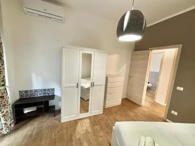 a bedroom with a white cabinet and a mirror at Your Home at Vatican's doors in Rome