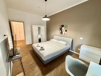 a bedroom with a bed and a chair in it at Your Home at Vatican's doors in Rome