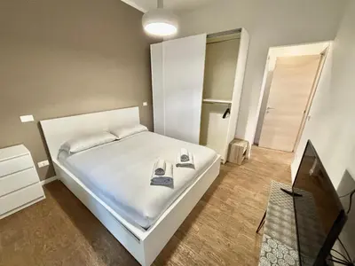 a small bedroom with a white bed and a television at Your Home at Vatican's doors in Rome