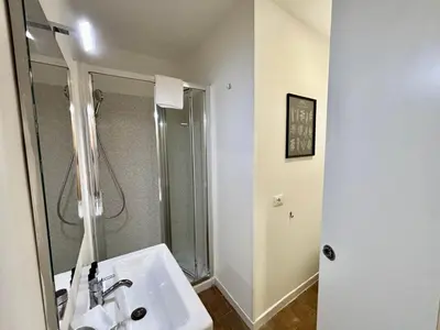 a white bathroom with a shower and a sink at Your Home at Vatican's doors in Rome