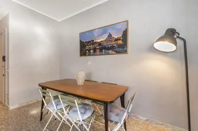 a dining room with a wooden table and chairs at Vatican 2bedr apt in Rome